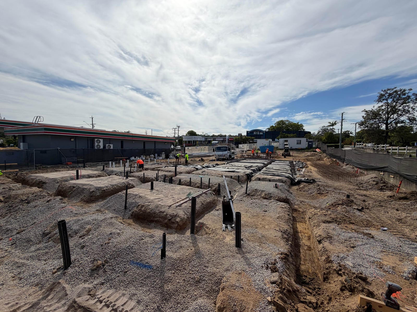 Commercial civil construction site with foundation preparation and pier holes