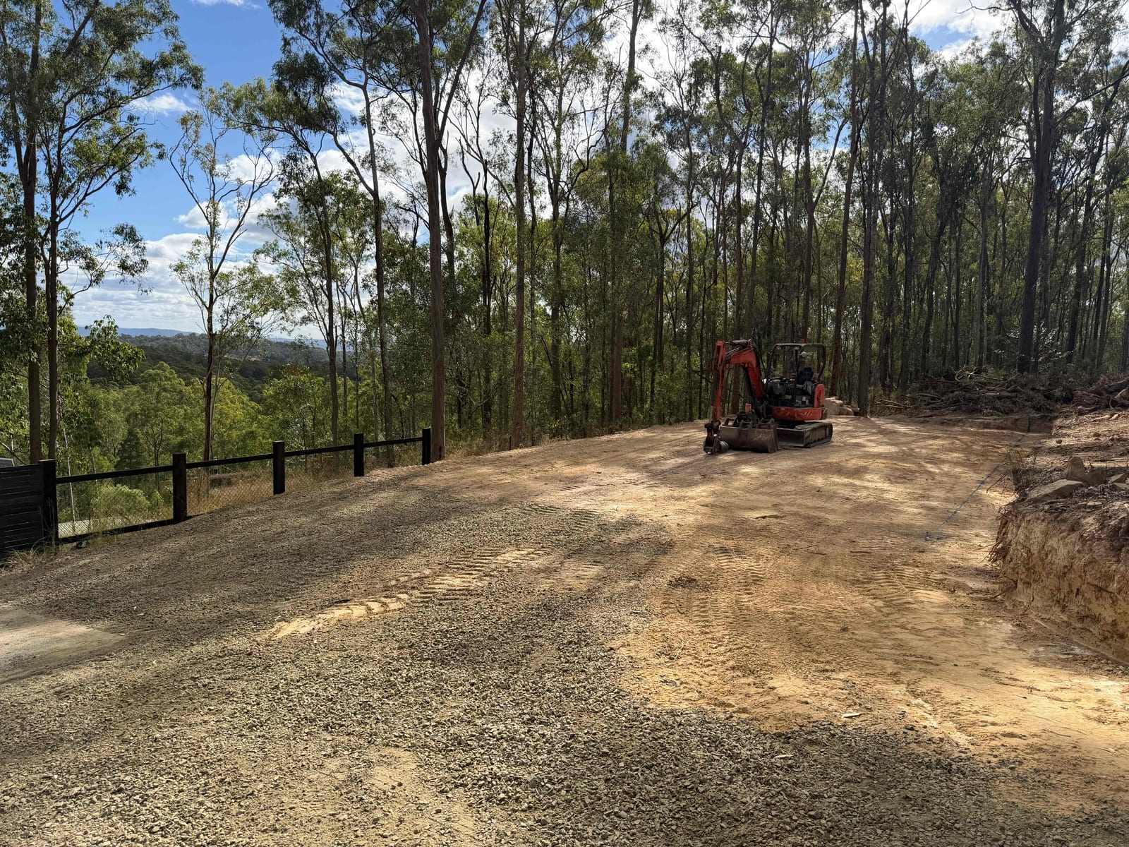 Excavator performing site grading on a Queensland bush block