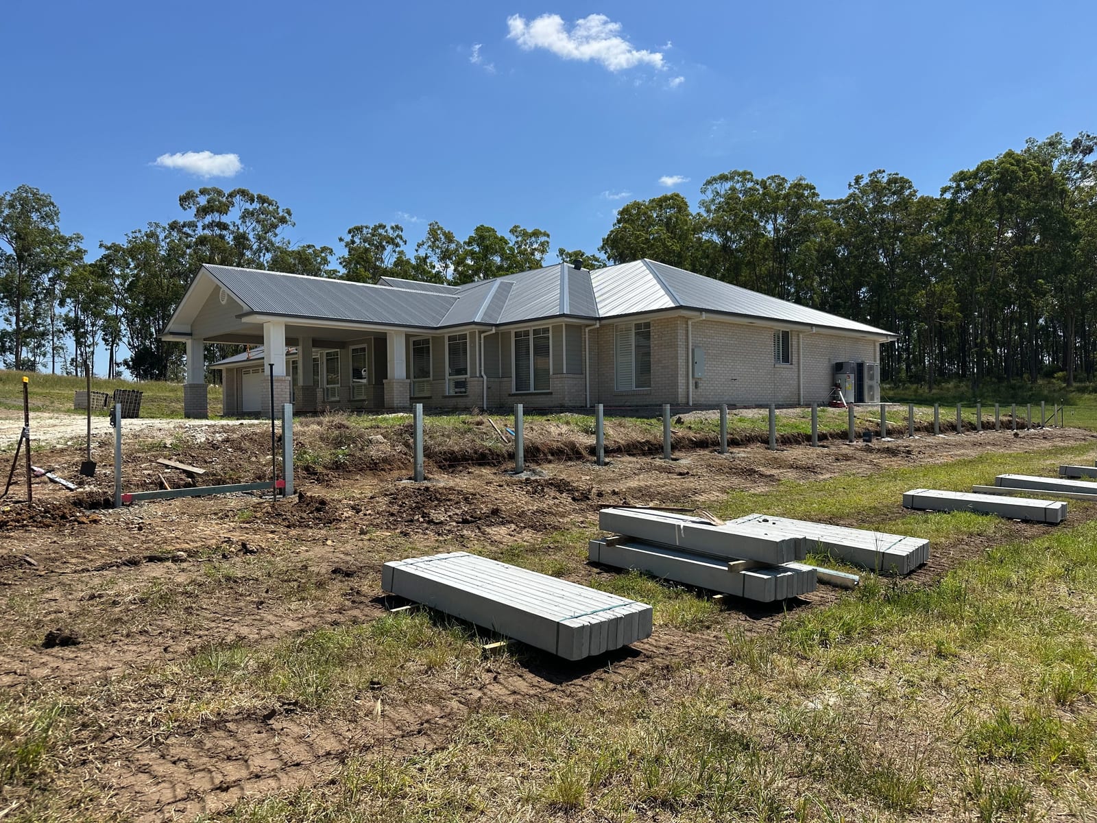Concrete sleeper fence post installation on rural property