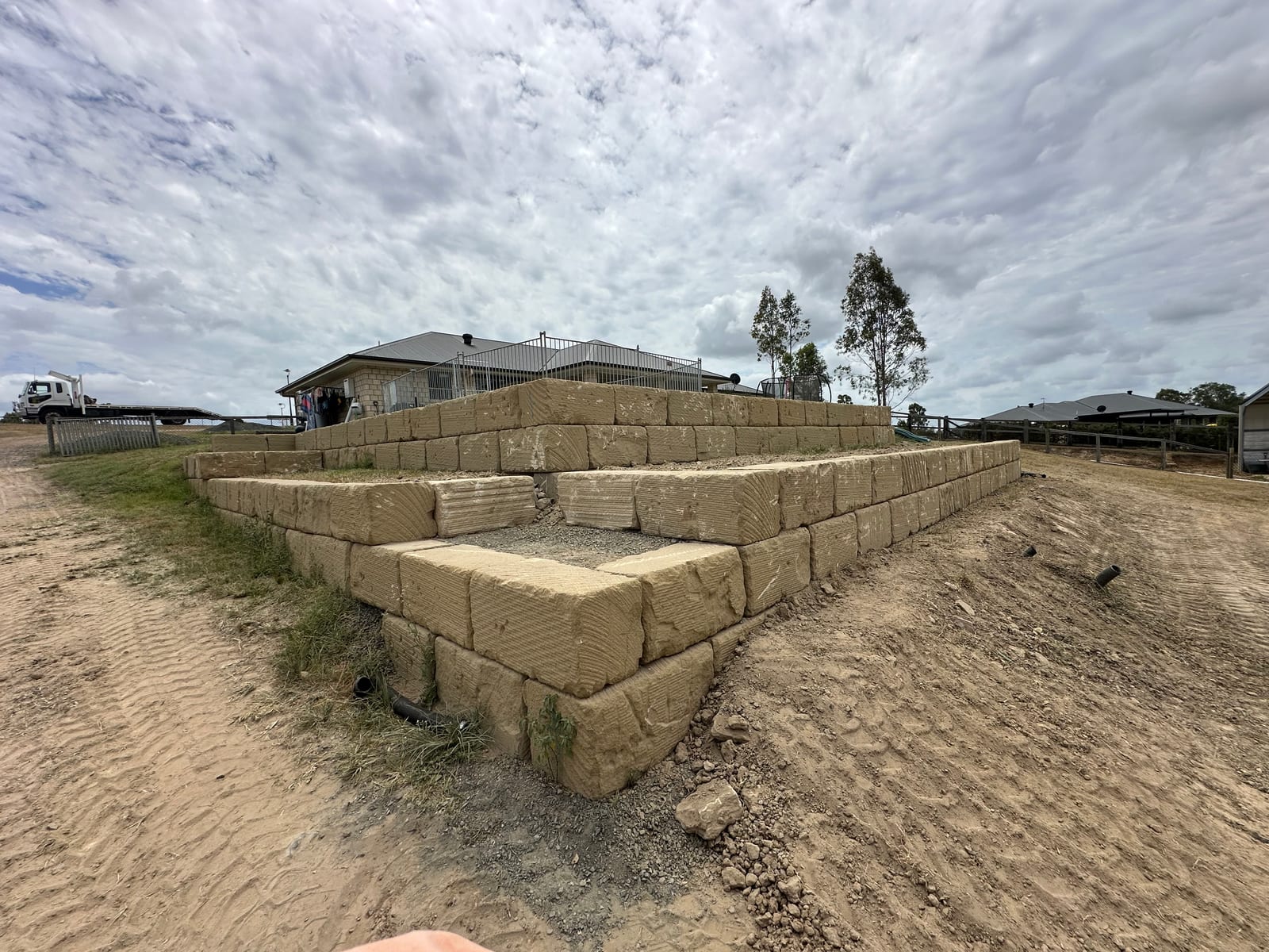 Tiered sandstone block retaining wall showing corner detail